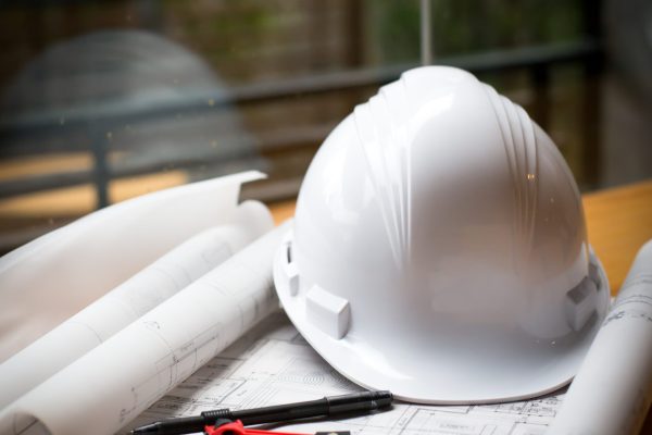 construction concept image helmet rolled blueprints on wooden bo construction concept image helmet rolled blueprints on wooden boards in retro style.
